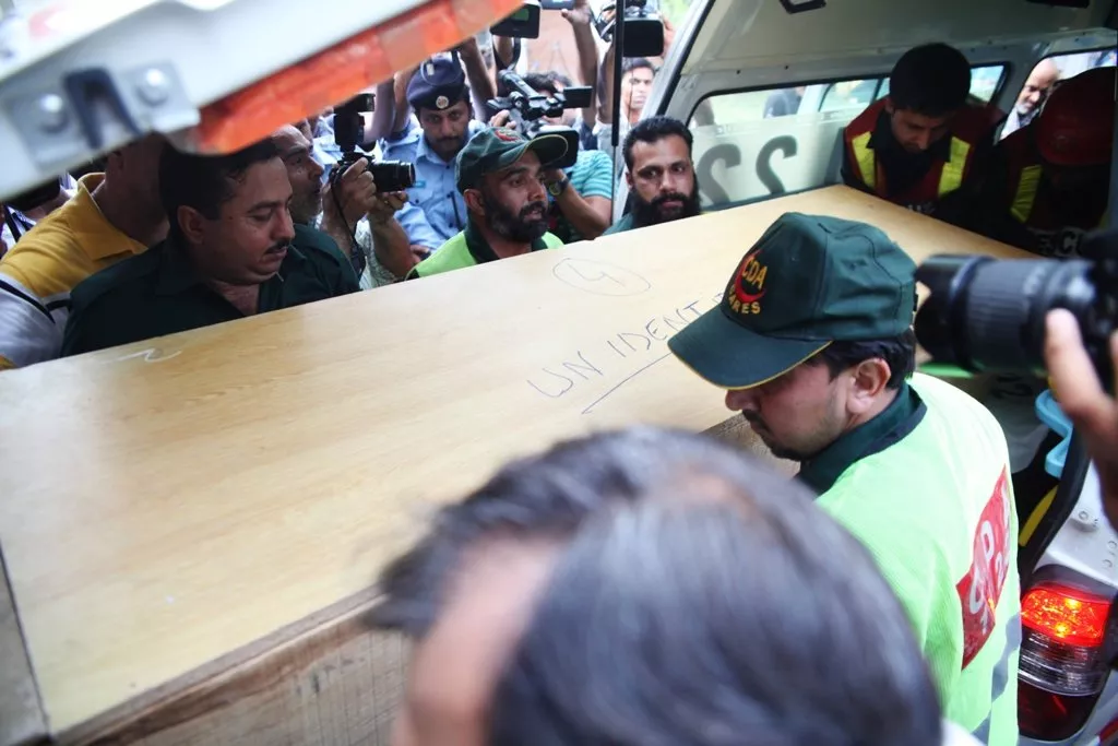 rescuers shift a coffin of a foreign tourist from an ambulance to a hospital in islamabad on june 23 2013 photo afp rescuers shift a coffin of a foreign tourist from an ambulance to a hospital in islamabad on june 23 2013 photo afp