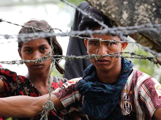rohingya refugees looks on through barbed wire as they wait for a boat to cross the border in maungdaw myanmar on september 7th photo reuters rohingya refugees looks on through barbed wire as they wait for a boat to cross the border in maungdaw myanmar on september 7th photo reuters