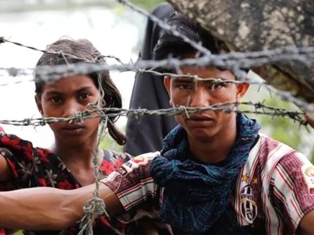 rohingya refugees looks on through barbed wire as they wait for a boat to cross the border in maungdaw myanmar on september 7th photo reuters rohingya refugees looks on through barbed wire as they wait for a boat to cross the border in maungdaw myanmar on september 7th photo reuters
