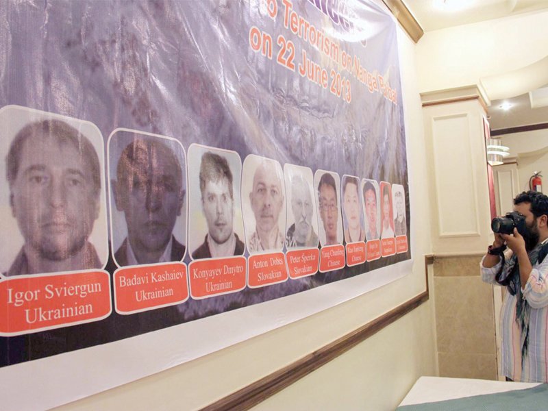 a banner displaying the slain mountaineers of the nanga parbat tragedy at a condolence meeting in islamabad photo inp