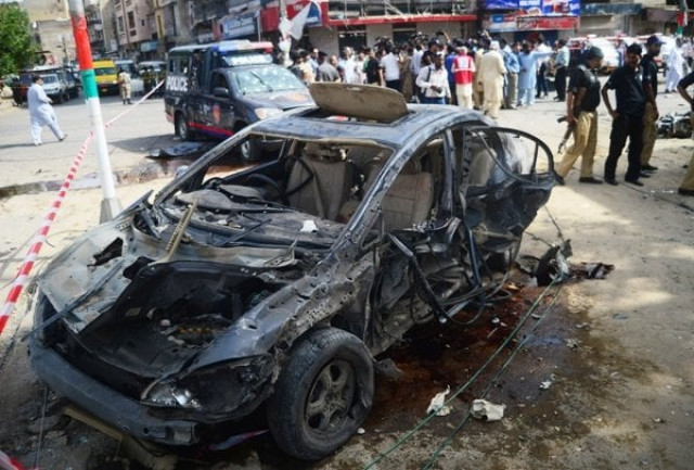security personnel gather around the car of maqbool baqir a senior judge that was injured in a bomb attack in karachi on june 26 2013 photo afp security personnel gather around the car of maqbool baqir a senior judge that was injured in a bomb attack in karachi on june 26 2013 photo afp