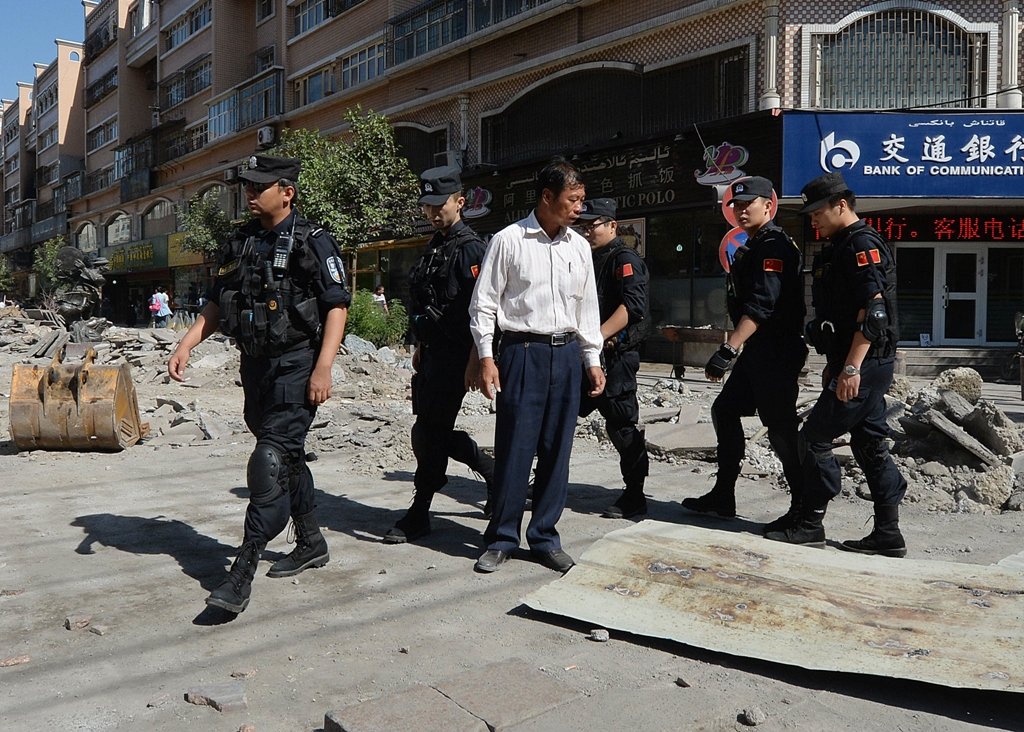 chinese armed police patrol the streets of the muslim uighur quarter in urumqi on june 29 2013 after a series of recent terrorist attacks hit the xinjiang region photo afp