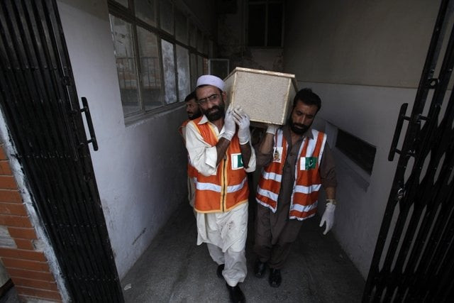 rescue workers carry a casket of a man who was killed in the bomb attack in peshawar june 30 2013 photo reuters rescue workers carry a casket of a man who was killed in the bomb attack in peshawar june 30 2013 photo reuters