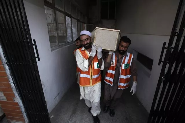 rescue workers carry a casket of a man who was killed in the bomb attack in peshawar june 30 2013 photo reuters rescue workers carry a casket of a man who was killed in the bomb attack in peshawar june 30 2013 photo reuters
