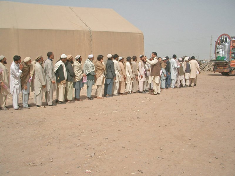 due to the sheer number of people at jalozai camp idp s have to wait for hours to receive rations and supplies photo express