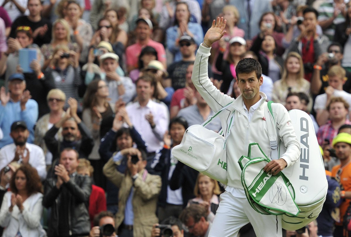 serbia 039 s novak djokovic gives a wave as he leaves the court after beating france 039 s jeremy chardy in their third round men 039 s singles match on day six of the 2013 wimbledon championships tennis tournament photo afp