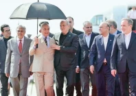 prime minister sharif holds an umbrella over visiting iranian president dr masoud pezeshkian as he and president asif ali zardari extend a cordial welcome upon his arrival at nur khan airbase photo ppi