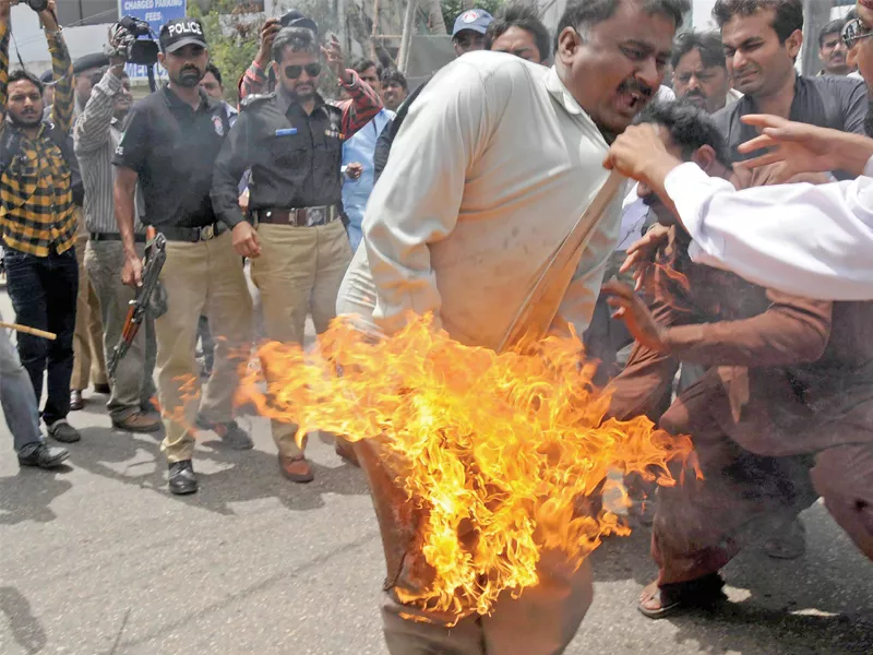 new teachers action committee chairperson abu bakr abro tried to set himself on fire during a protest rally against unpaid salaries photo rashid ajmeri express new teachers action committee chairperson abu bakr abro tried to set himself on fire during a protest rally against unpaid salaries photo rashid ajmeri express
