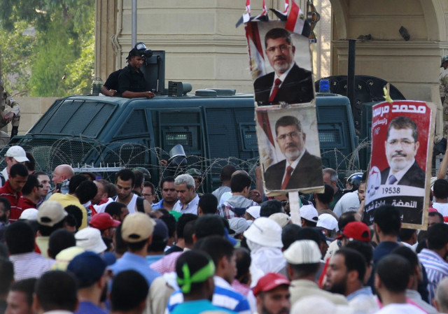 riot police rear keep watch over supporters of deposed egypt 039 s president mohamed mursi gathered outside the republican guard barracks where mursi is held in cairo photo reuters riot police rear keep watch over supporters of deposed egypt 039 s president mohamed mursi gathered outside the republican guard barracks where mursi is held in cairo photo reuters