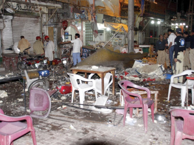 police and rescuers examine the site after the blast photo abid nawaz express police and rescuers examine the site after the blast photo abid nawaz express