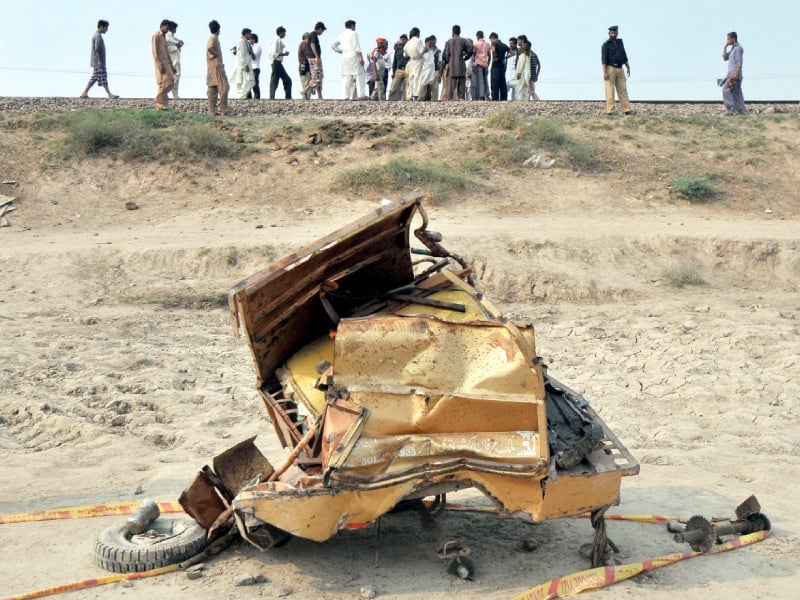 the mangled wreckage of a rickshaw after a train collided with the vehicle photo afp