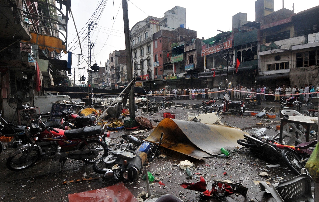 local residents gather at the site of an overnight bomb explosion at a food park in lahore on july 7 photo afp