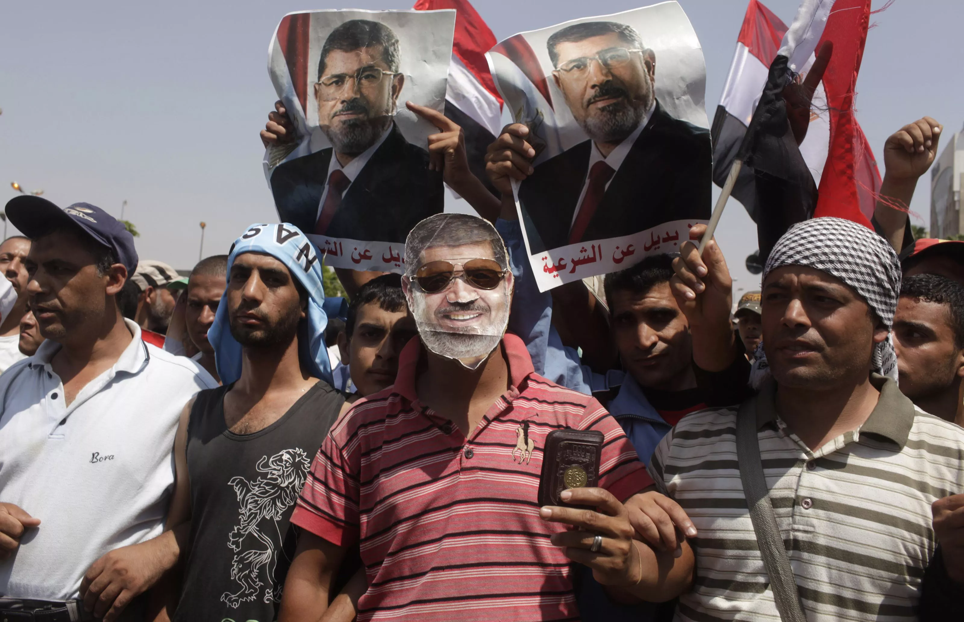 a supporter of deposed egyptian president mohamed mursi wears a mask depicting mursi as protesters chant slogans outside the republican guard headquarters in cairo july 7 2013 photo reuters a supporter of deposed egyptian president mohamed mursi wears a mask depicting mursi as protesters chant slogans outside the republican guard headquarters in cairo july 7 2013 photo reuters