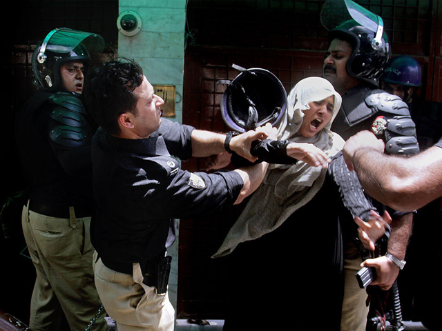 a police officer scuffles with a female protester during clashes in lahore tuesday june 17 2014 photo ap