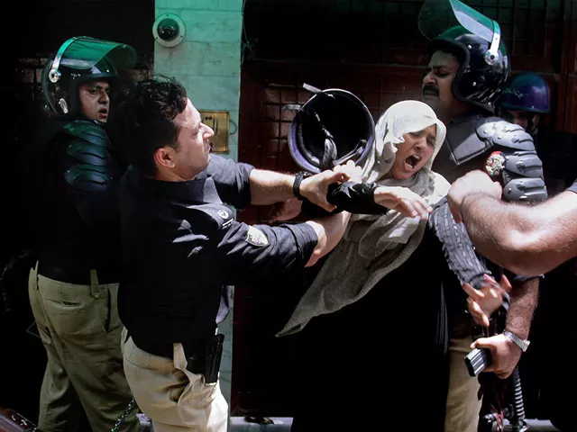 a police officer scuffles with a female protester during clashes in lahore tuesday june 17 2014 photo ap a police officer scuffles with a female protester during clashes in lahore tuesday june 17 2014 photo ap