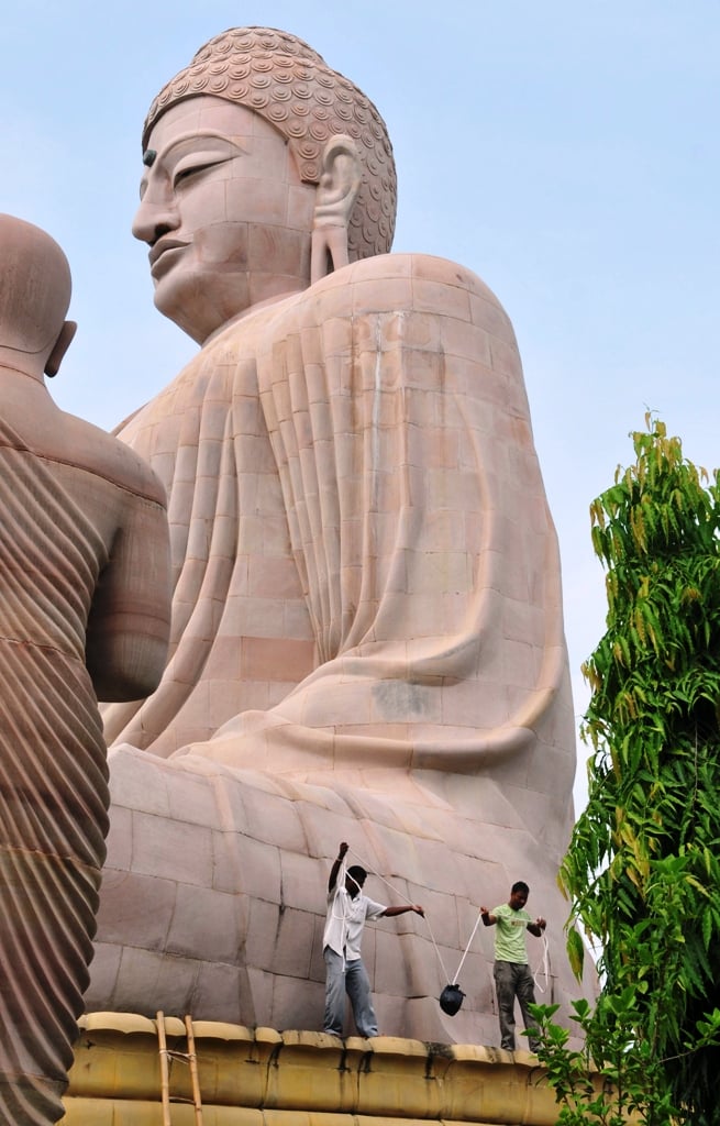 in this photograph taken on july 7 2013 indian bomb disposal personnel recover an unexploded bomb from the great statue of lord buddha following eight low intensity serial blasts at the bodh gaya temple complex in bodh gaya photo afp