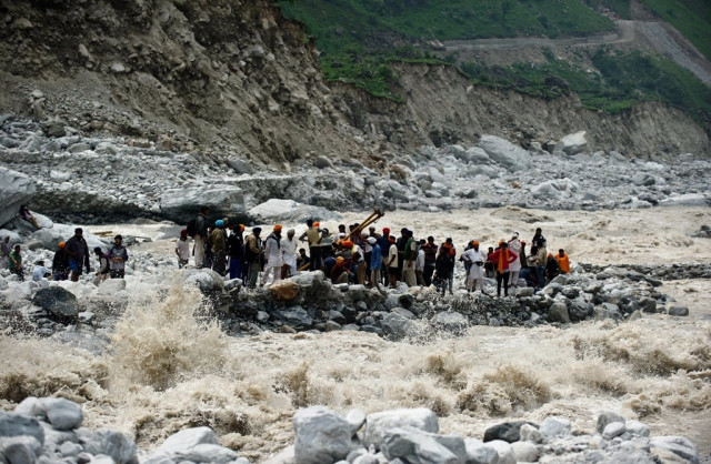 n this photograph taken on june 23 2013 stranded indian pilgrims wait to be rescued on the side of a river at govind ghat photo afp n this photograph taken on june 23 2013 stranded indian pilgrims wait to be rescued on the side of a river at govind ghat photo afp