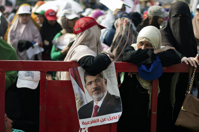 an egyptian woman lean on a barrier as thousands of muslim brotherhood members and supporters of ousted president mohamed morsi gather in front of rabaa al adawiya mosque in cairo photo afp an egyptian woman lean on a barrier as thousands of muslim brotherhood members and supporters of ousted president mohamed morsi gather in front of rabaa al adawiya mosque in cairo photo afp