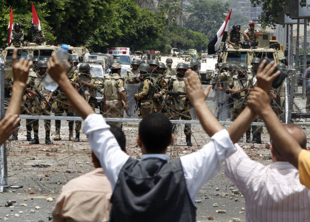 members of the muslim brotherhood and supporters of deposed egyptian president mohamed mursi shout slogans in front of army soldiers at republican guard headquarters in nasr city in the suburb of cairo july 8 2013 photo reuters