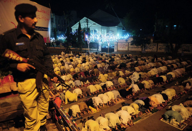 a pakistani policeman stands guard as people perform the special evening prayer quot taraweeh quot on the eve of ramazan photo afp a pakistani policeman stands guard as people perform the special evening prayer quot taraweeh quot on the eve of ramazan photo afp