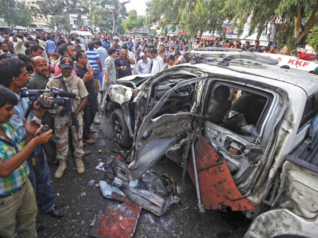 rangers and media persons stand near the wreckage of the vehicle of president zardari s chief security officer after the blast photo reuters