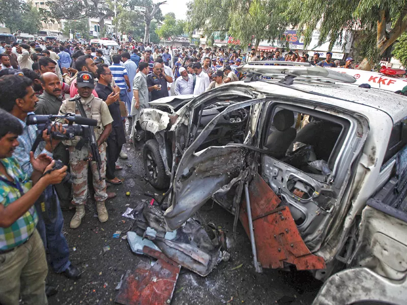 rangers and media persons stand near the wreckage of the vehicle of president zardari s chief security officer after the blast photo reuters rangers and media persons stand near the wreckage of the vehicle of president zardari s chief security officer after the blast photo reuters