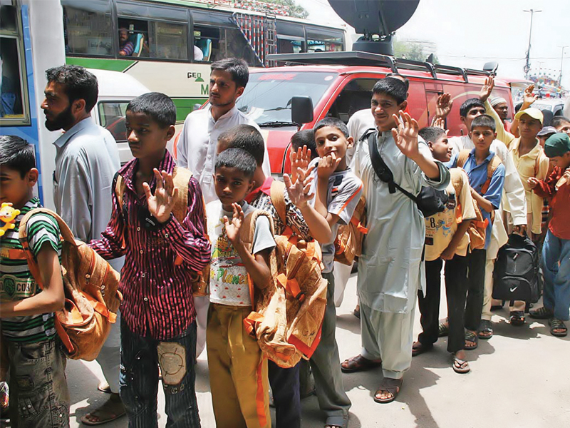 children who have been living at edhi centre boarding buses at tower on friday to go around the country and look for their families photo online