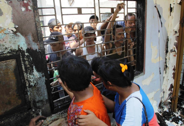 in this photo taken on july 12 2013 two women take a look at tanjung gusta jail from the window after a riot at tanjung gusta jail in medan city north sumatra photo afp in this photo taken on july 12 2013 two women take a look at tanjung gusta jail from the window after a riot at tanjung gusta jail in medan city north sumatra photo afp