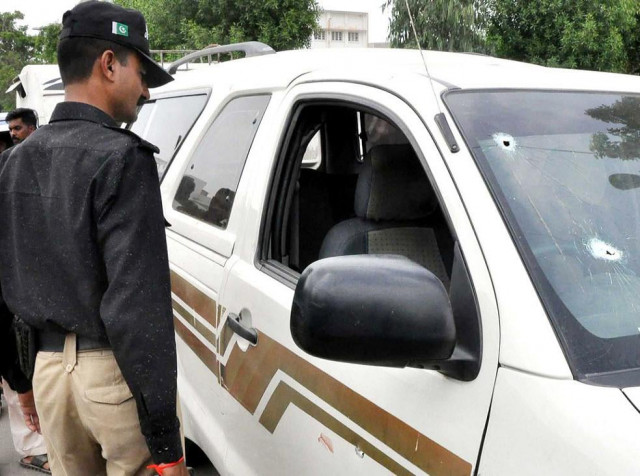 an officer looks at the bullet riddled car of sp malik maqsood photo nni file an officer looks at the bullet riddled car of sp malik maqsood photo nni file