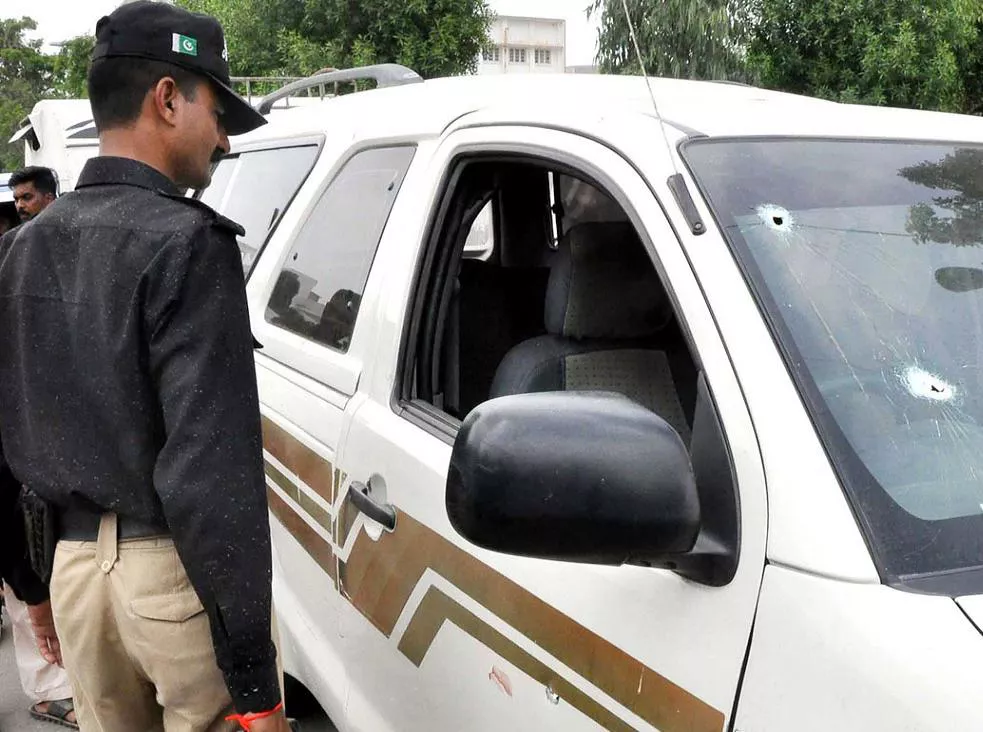 an officer looks at the bullet riddled car of sp malik maqsood photo nni file an officer looks at the bullet riddled car of sp malik maqsood photo nni file