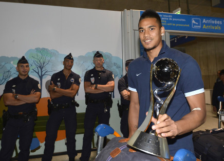 under 20 french team goalkeeper alphonse areola poses with the trophy while arriving with his teammates at the roissy charles de gaulle airport on july 14 2013 a day after defeating uruguay during their fifa under 20 world cup final football match in istanbul photo afp