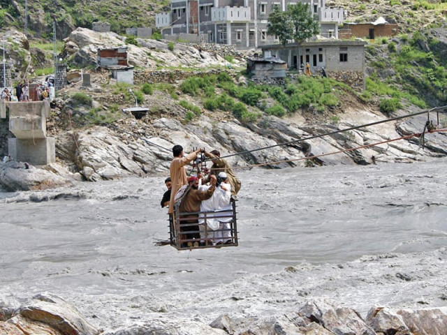at least six men are seen crossing the river on one rickety chairlift after kund bridge was swept away in 2010 floods photo online at least six men are seen crossing the river on one rickety chairlift after kund bridge was swept away in 2010 floods photo online