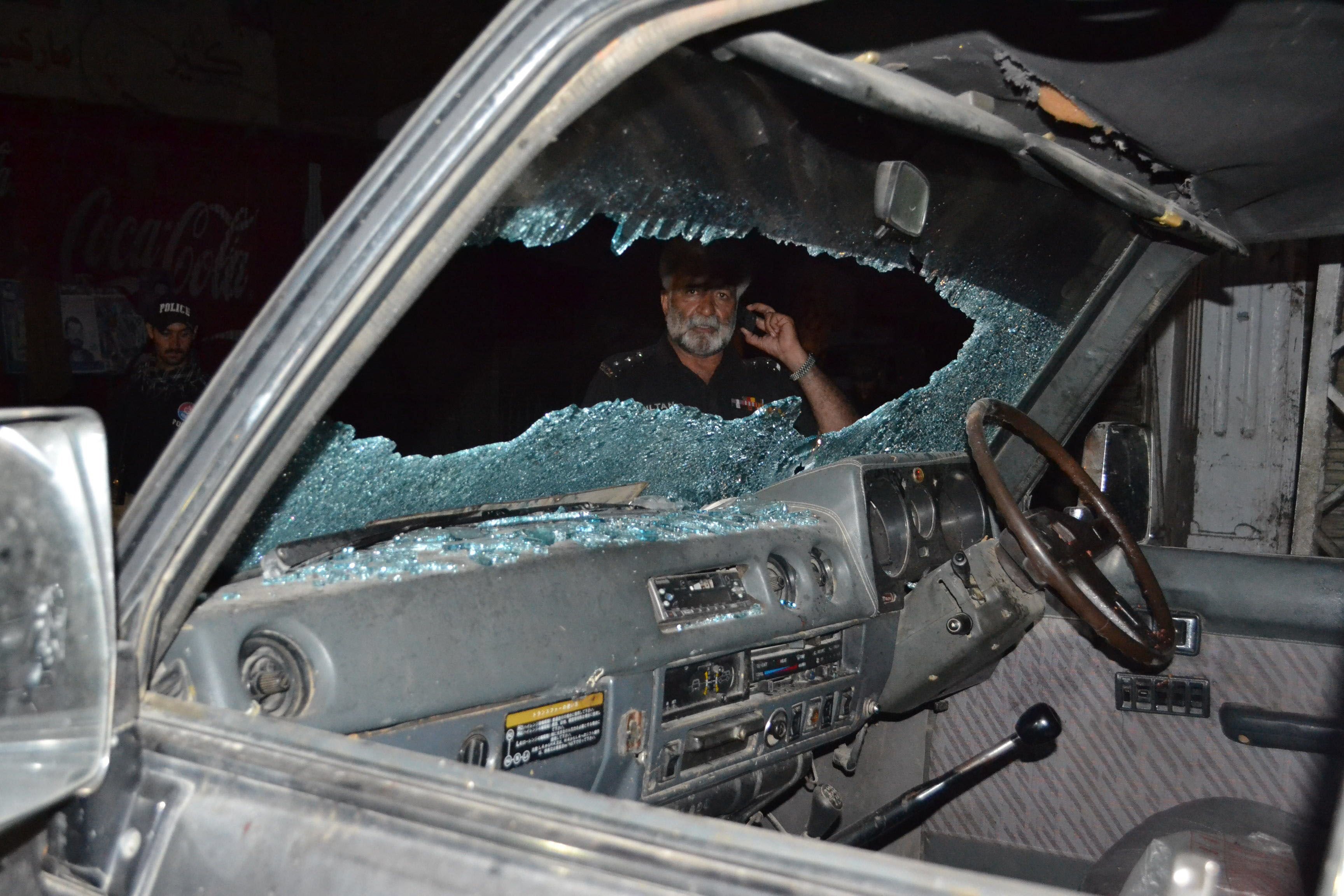 a pakistani police officer looks at a bullet riddled vehicle after an attack by gunmen in quetta on july 15 2013 photo afp