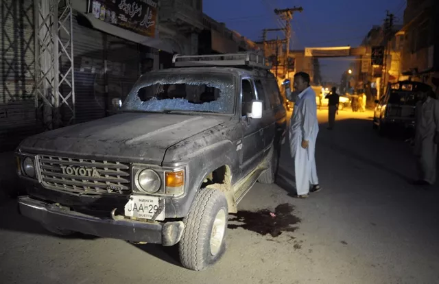 a pakistani plainclothes police officer looks at a bullet riddled vehicle after an attack by gunmen in quetta on july 15 2013 photo afp a pakistani plainclothes police officer looks at a bullet riddled vehicle after an attack by gunmen in quetta on july 15 2013 photo afp