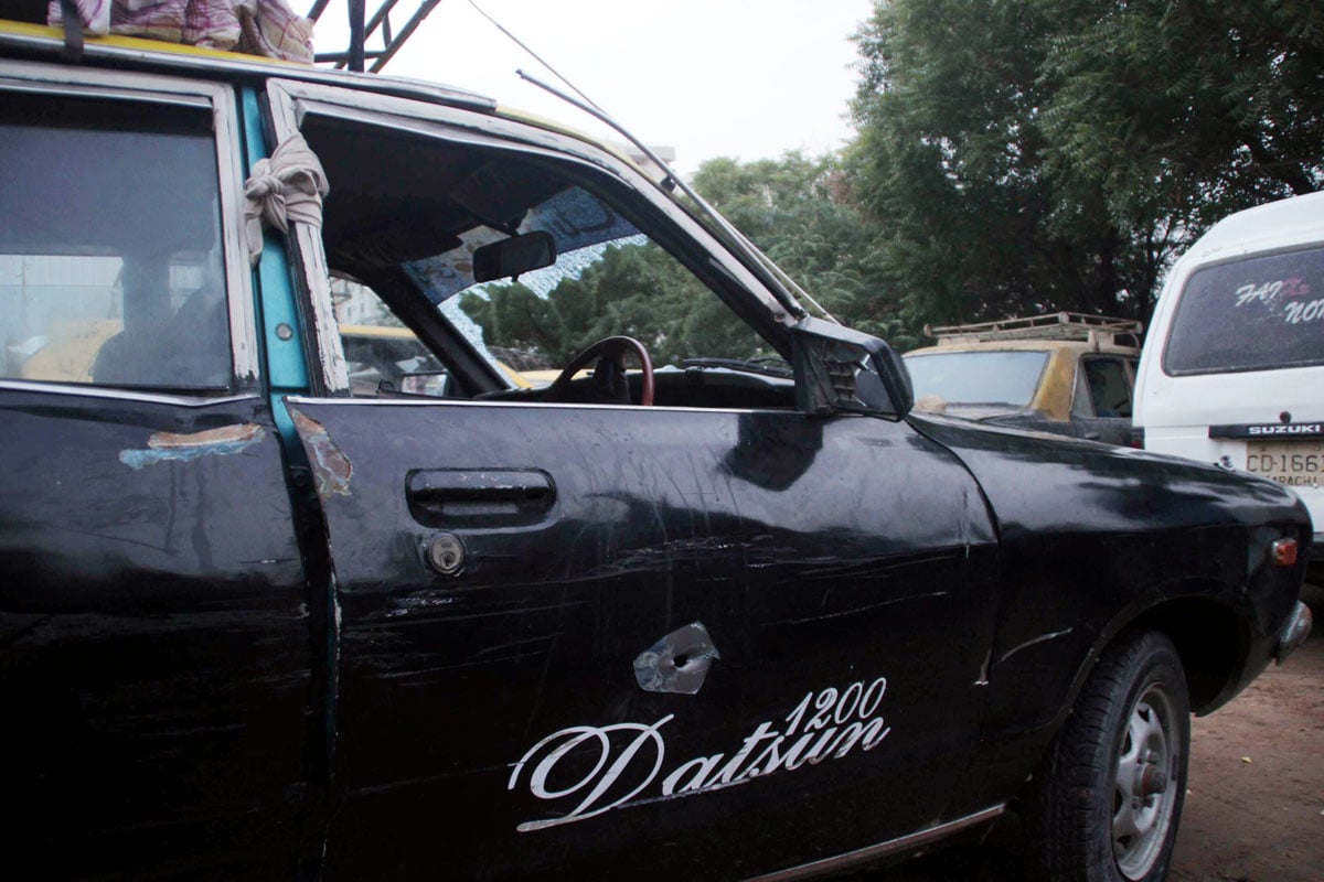 the taxi that was fired upon by rangers the windshield of the cab is shattered and there is a bullet hole on the driver side photo mohammad noman express