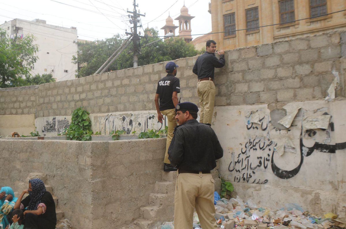 police officers inspect the place from where a prisoner escaped from the city courts on tuesday photo mohammad sqib express