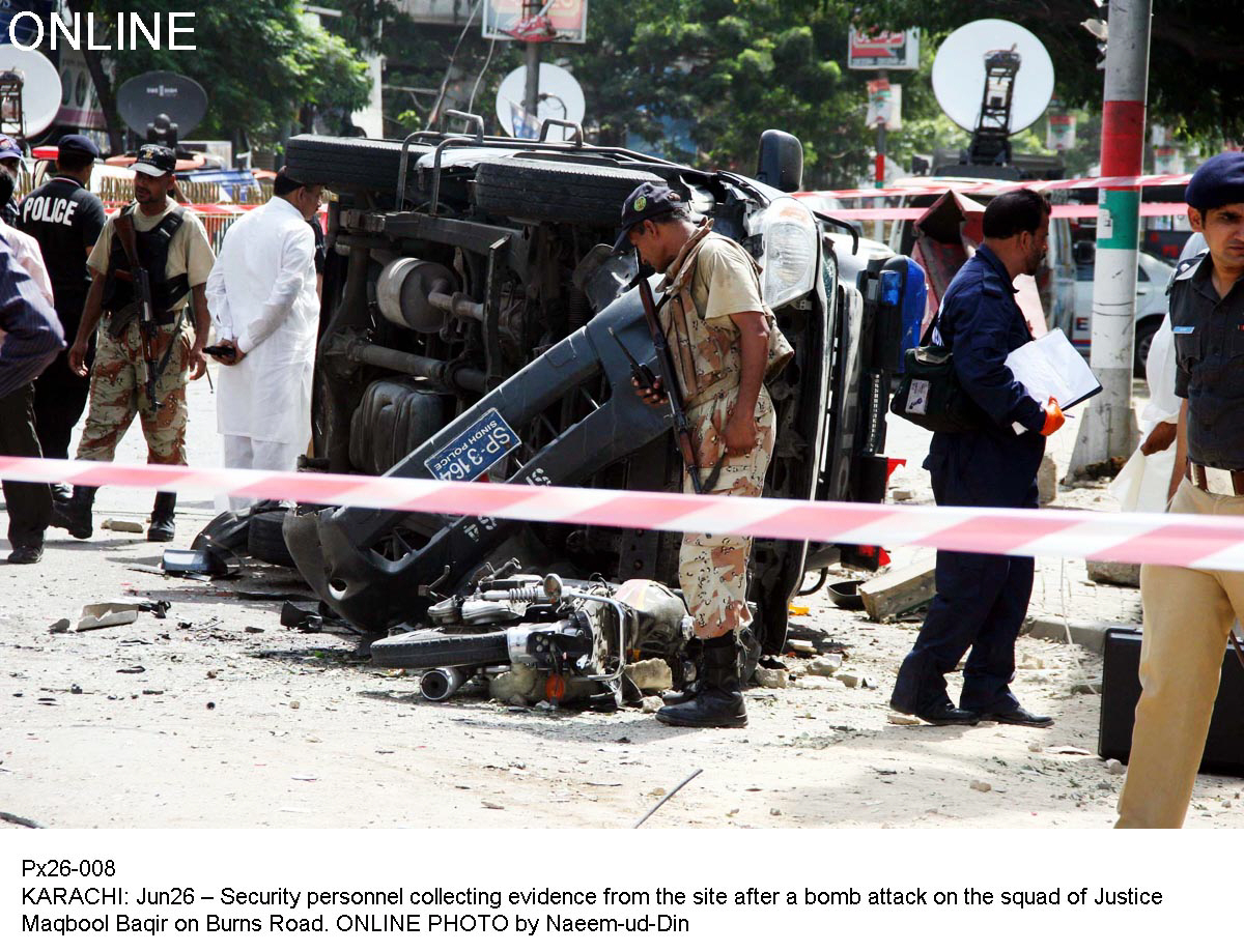 officials inspect the aftermath of a bomb attack on a sindh high court judge in karachi photo online