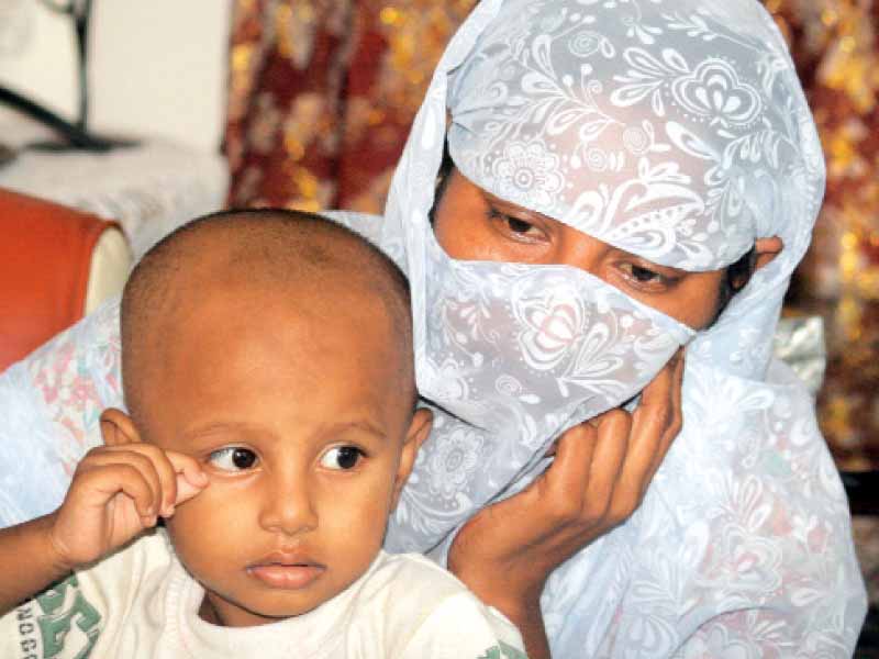 dua holds on to one and a half year old zohaib at murad s brother s residence photo athar khan express