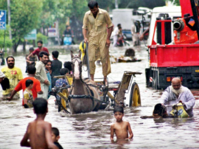 a man manoeuvres his horse cart through lakshmi chowk which was flooded after the heavy downpour on saturday photo abid nawaz express a man manoeuvres his horse cart through lakshmi chowk which was flooded after the heavy downpour on saturday photo abid nawaz express