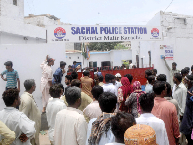 friends family and neighbours of bilal aka mullah who died in police s custody on friday protest outside the sacchal police station the protesters dispersed after the police registered an fir against the murder photo mohammad saqib express