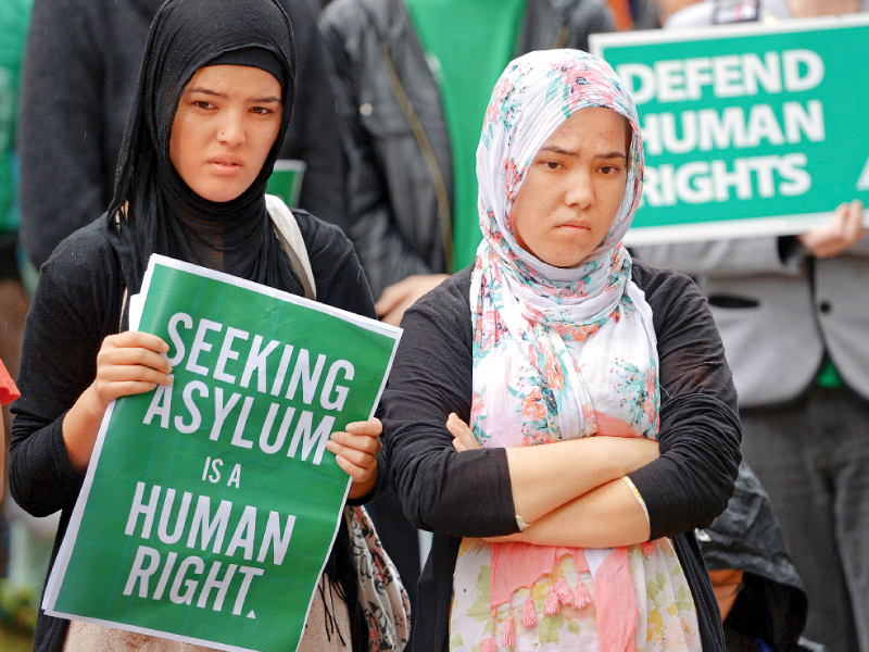 a hazara woman holds a poster during a rally in support of asylum seekers in sydney photo afp