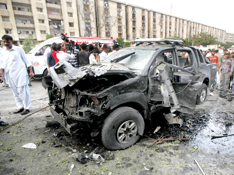 rescue workers and members of the media gather around the wreckage of the suv transporting metropolitan commissioner matanat ali khan photo athar khan express