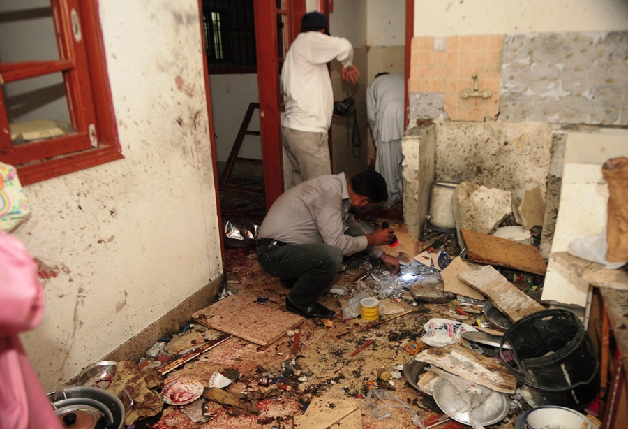 security personnel collect evidence at the site of a bomb blast in a house in karachi on july 20 2013 photo afp