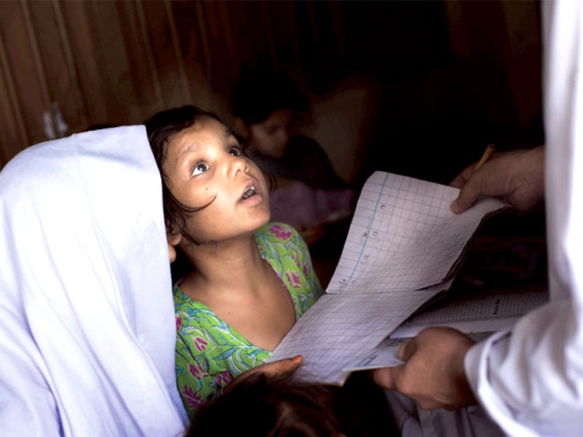 a student collecting her checked homework from a teacher photo myra iqbal express a student collecting her checked homework from a teacher photo myra iqbal express