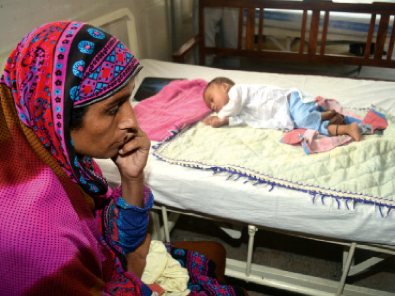 file photo of a mother visiting her sick child in a sargodha hospital photo shahid bukhari express