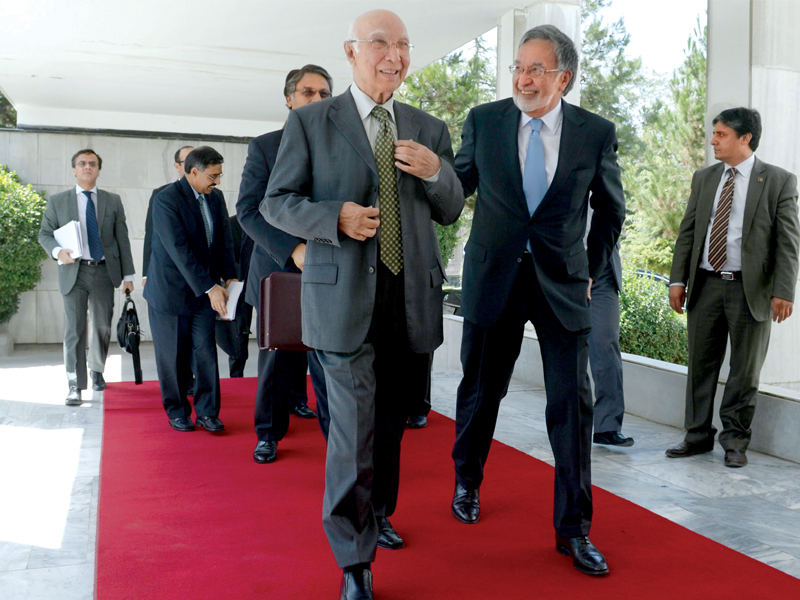 afghan foreign minister zalmay rassoul welcomes adviser to the pm on foreign affairs sartaj aziz at the foreign affairs ministry in kabul photo afp