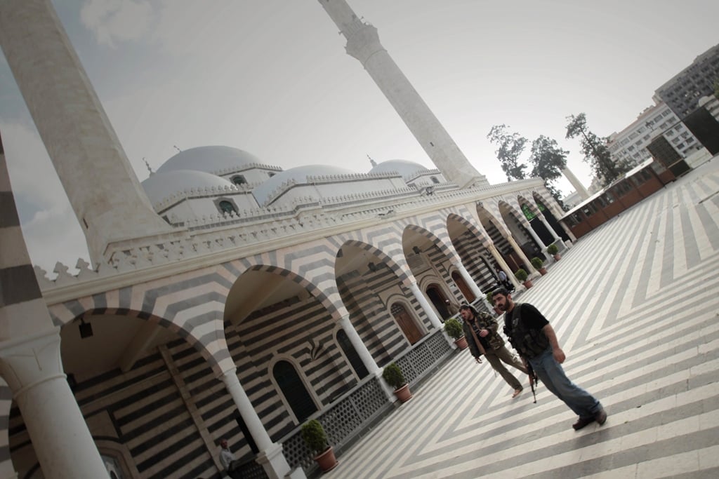 a picture taken on may 3 2012 shows free syrian army militants standing in the courtyard of the khaled ibn al walid mosque in the al khalidiyah neighbourhood of the central syrian city of homs quot activists from the khaldiyeh neighbourhood in the city of homs have reported the destruction by army shelling of the mausoleum of the prophet 039 s companion khaled bin walid quot said the syrian observatory for human rights photo afp