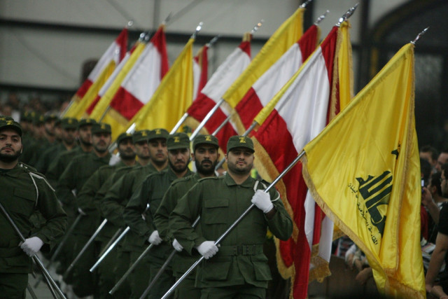 a picture taken on november 11 2009 shows hezbollah fighters holding up lebanese flags and the yellow flag of the militant shia muslim group as they parade on the occasion of martyr 039 s day in the southern suburbs of beirut photo afp file a picture taken on november 11 2009 shows hezbollah fighters holding up lebanese flags and the yellow flag of the militant shia muslim group as they parade on the occasion of martyr 039 s day in the southern suburbs of beirut photo afp file