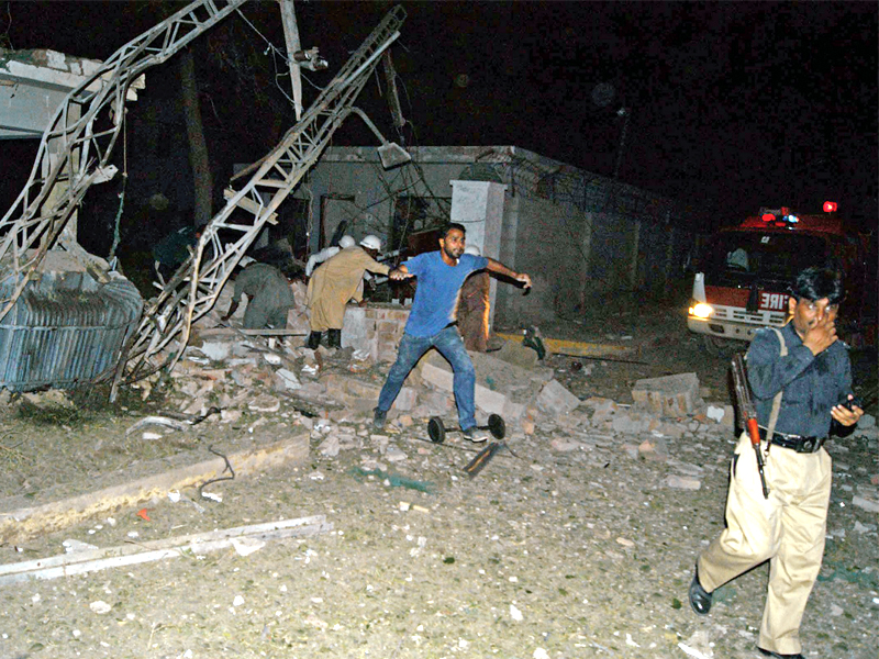 policemen and rescuers at the site of suicide attack in sukkur photo afp