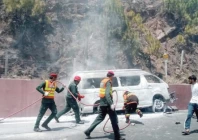 rescue workers extinguish fire on a van near khajut on the islamabad murree expressway photo express
